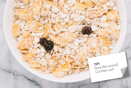 bowl of oats flavoured with cinnamon and raisins